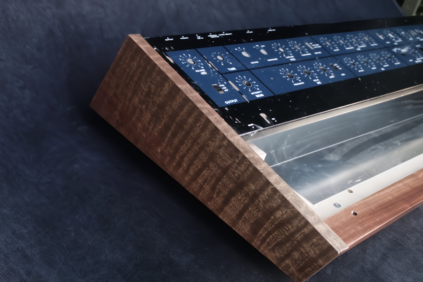 Korg Polysix wooden case crafted from Sapele wood with striking tiger stripe patterns.