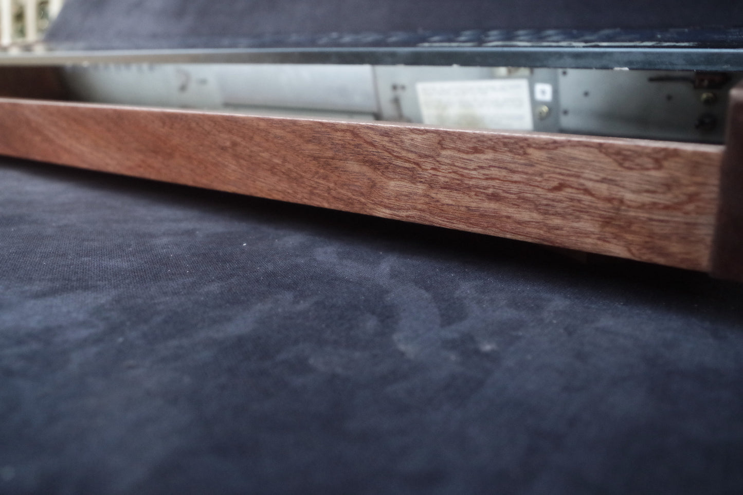 Korg Polysix wooden case crafted from Sapele wood with striking tiger stripe patterns.