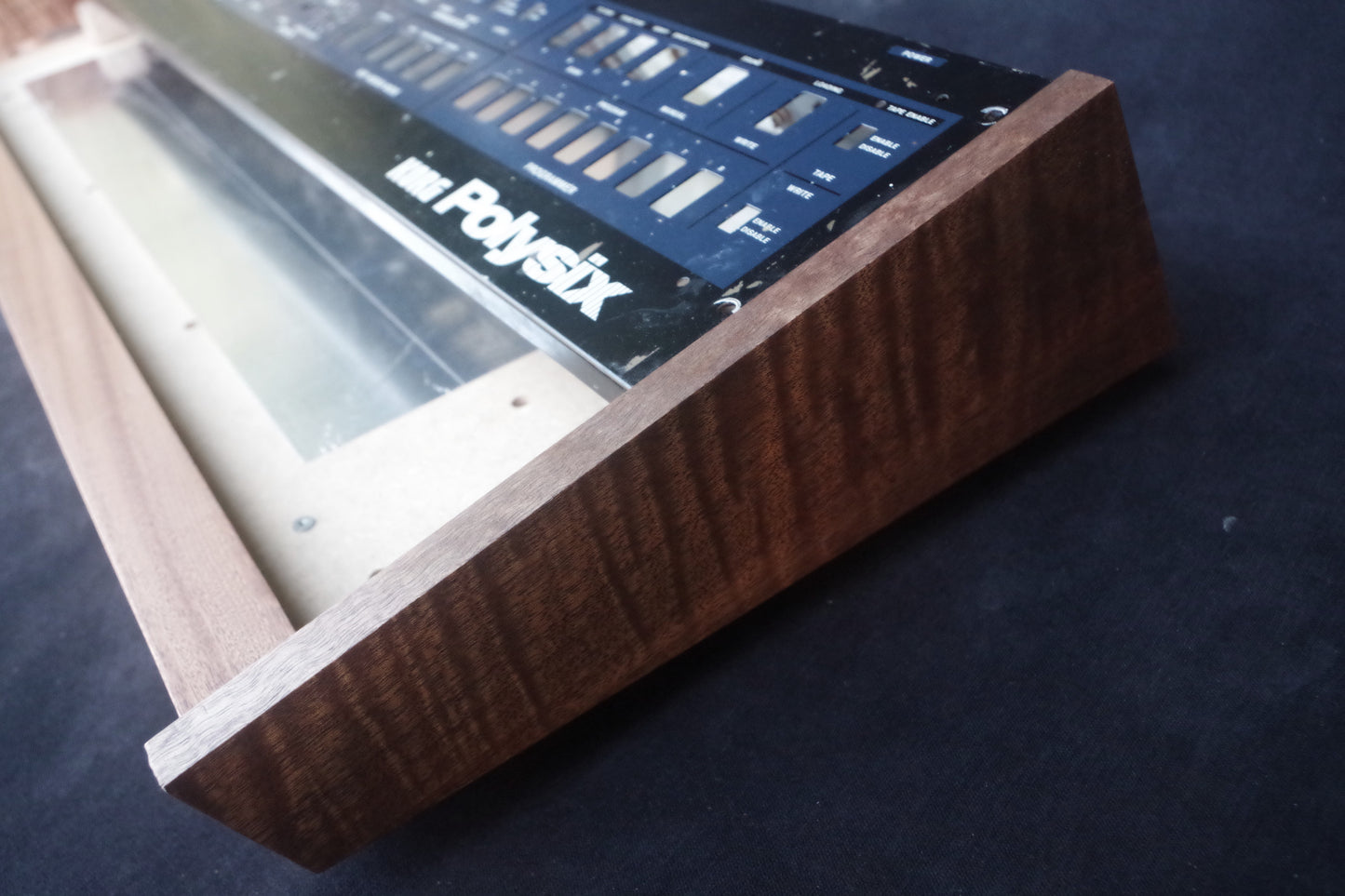 Korg Polysix wooden case crafted from Sapele wood with striking tiger stripe patterns.
