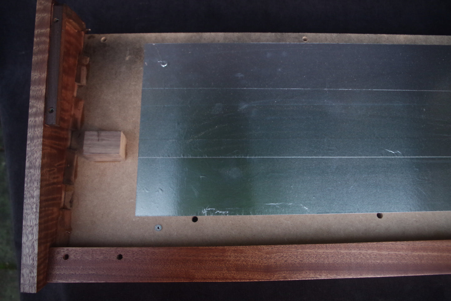 Korg Polysix wooden case crafted from Sapele wood with striking tiger stripe patterns.