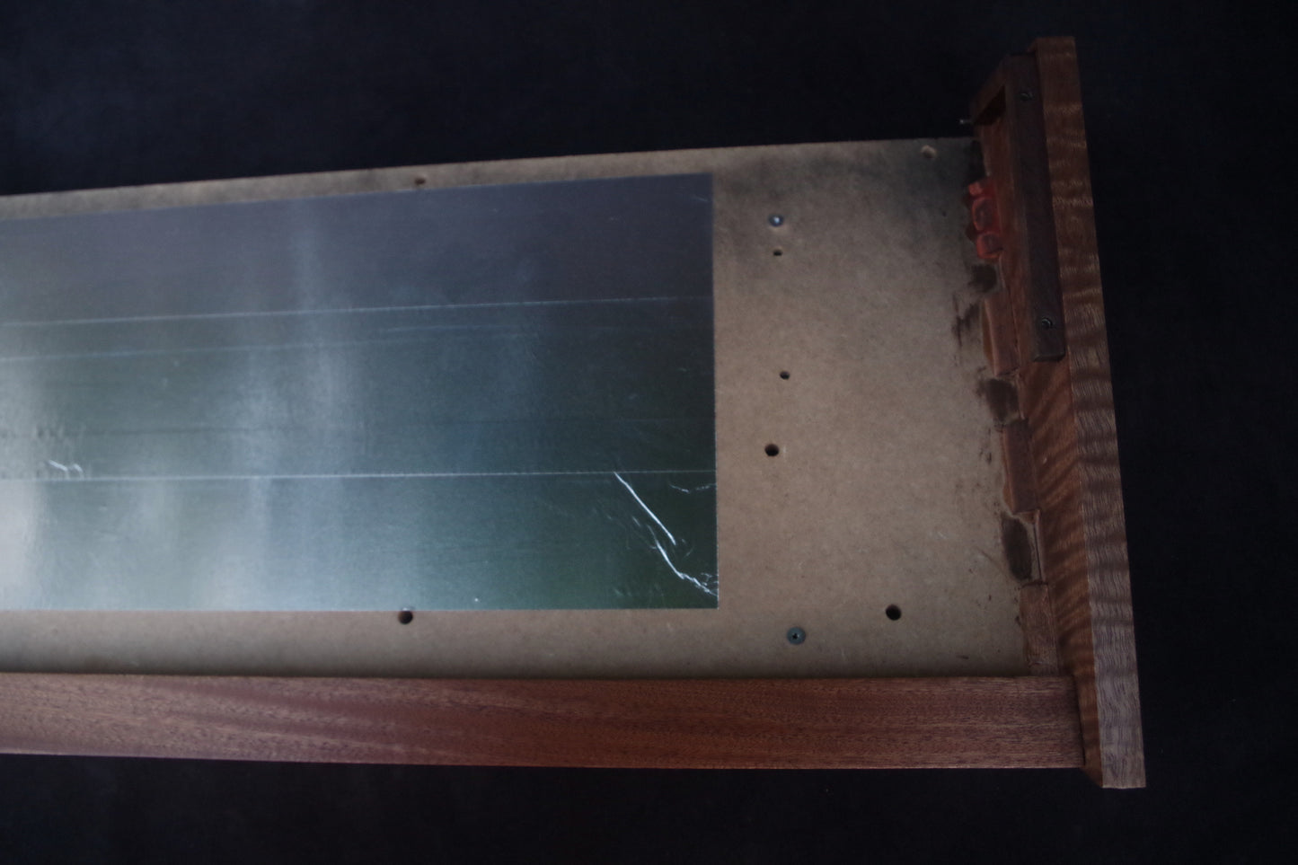 Korg Polysix wooden case crafted from Sapele wood with striking tiger stripe patterns.
