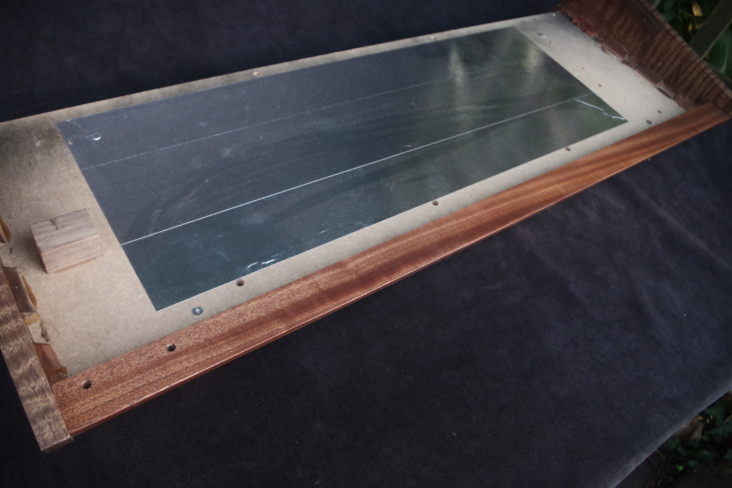 Korg Polysix wooden case crafted from Sapele wood with striking tiger stripe patterns.
