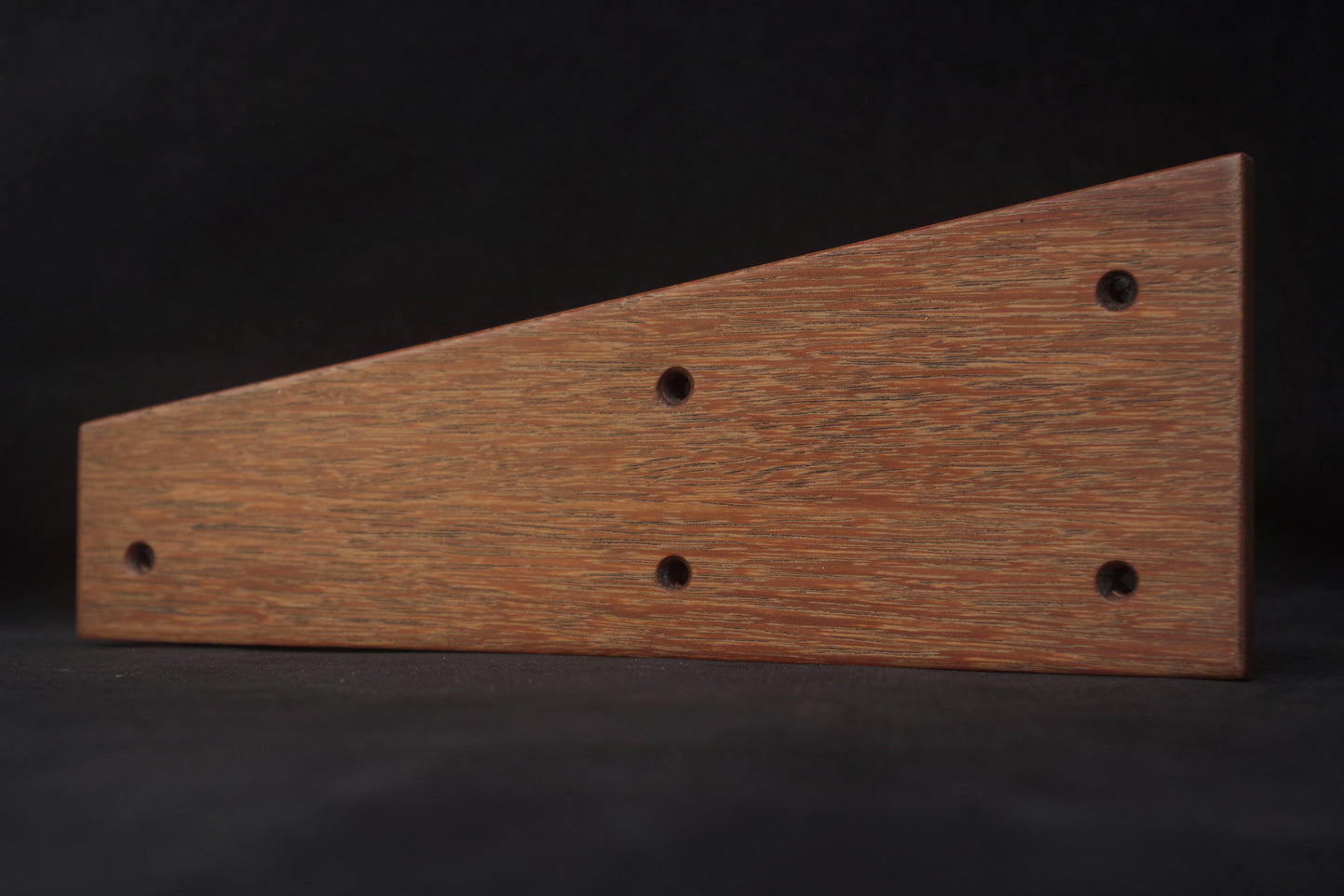 Iroko wood grain close-up on Prophet 600 side panels